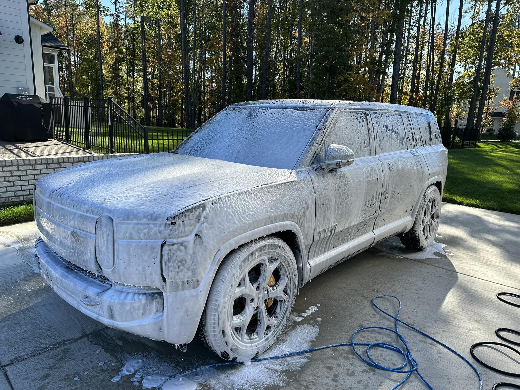 Rivian R1 soaked in soap from our foam cannon