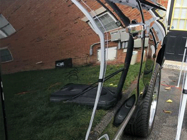 Black vehicle paint with a deep mirror shine after ceramic coating