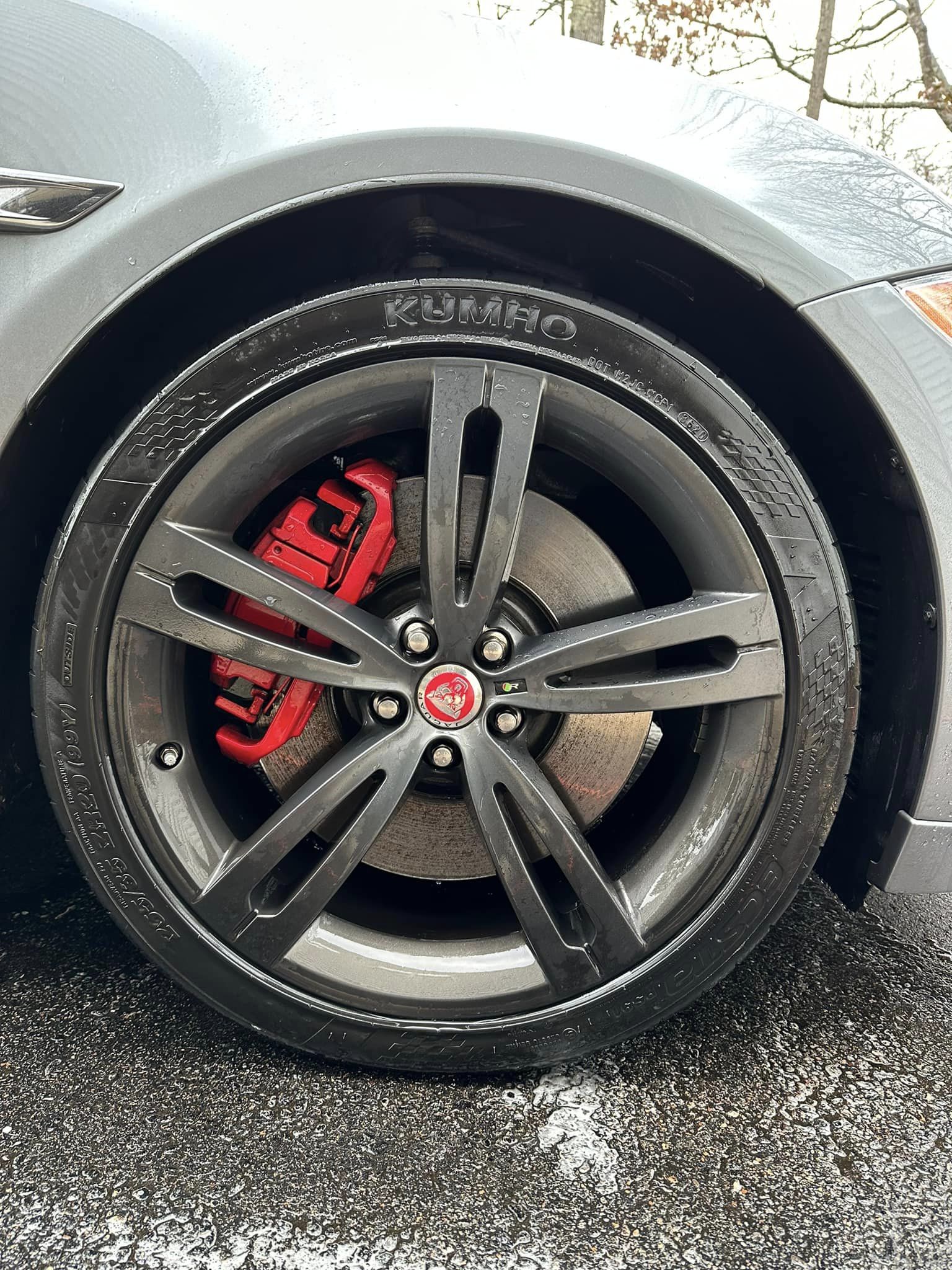A detailed wheel with a red brake caliper