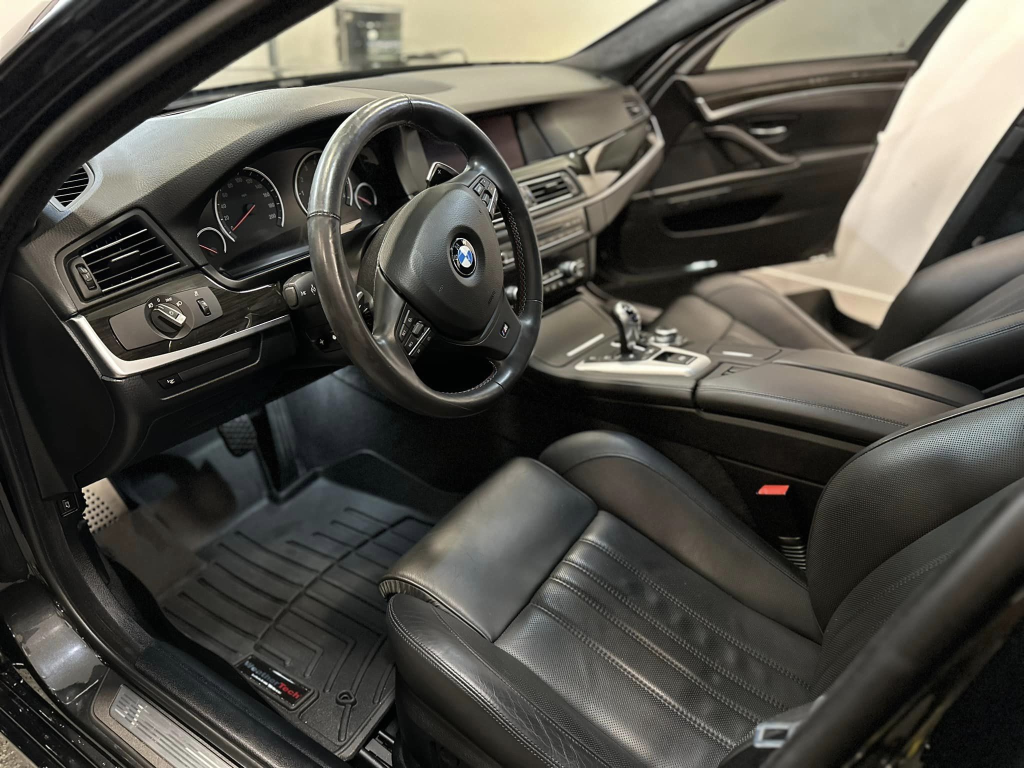 A black leather BMW interior meticulously detailed