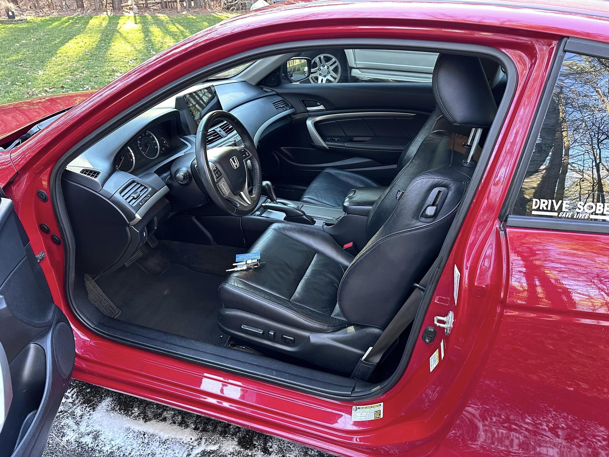 Black leather interior of a red Honda