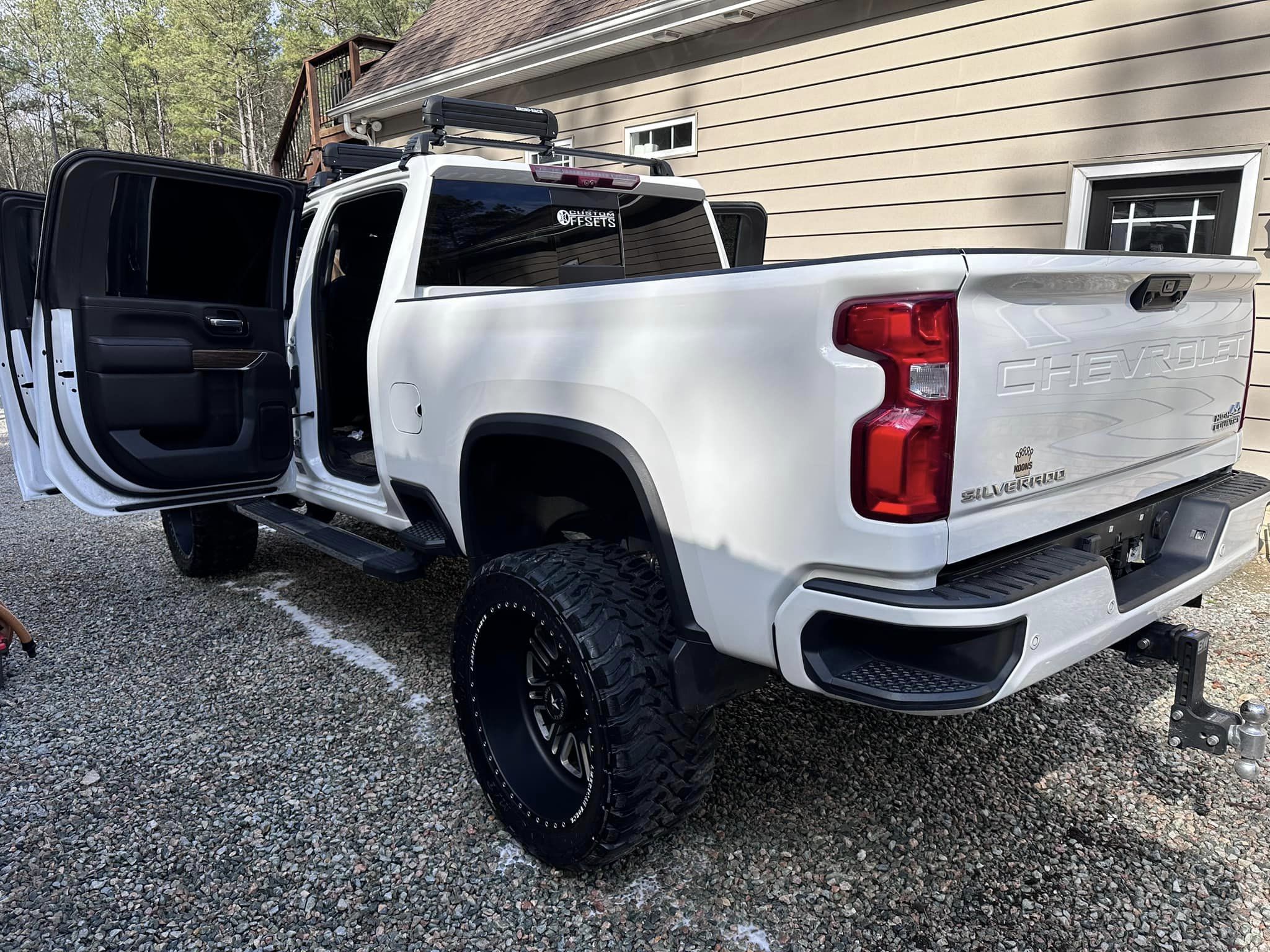 Rear quarter panel of a white Chevy Silverado