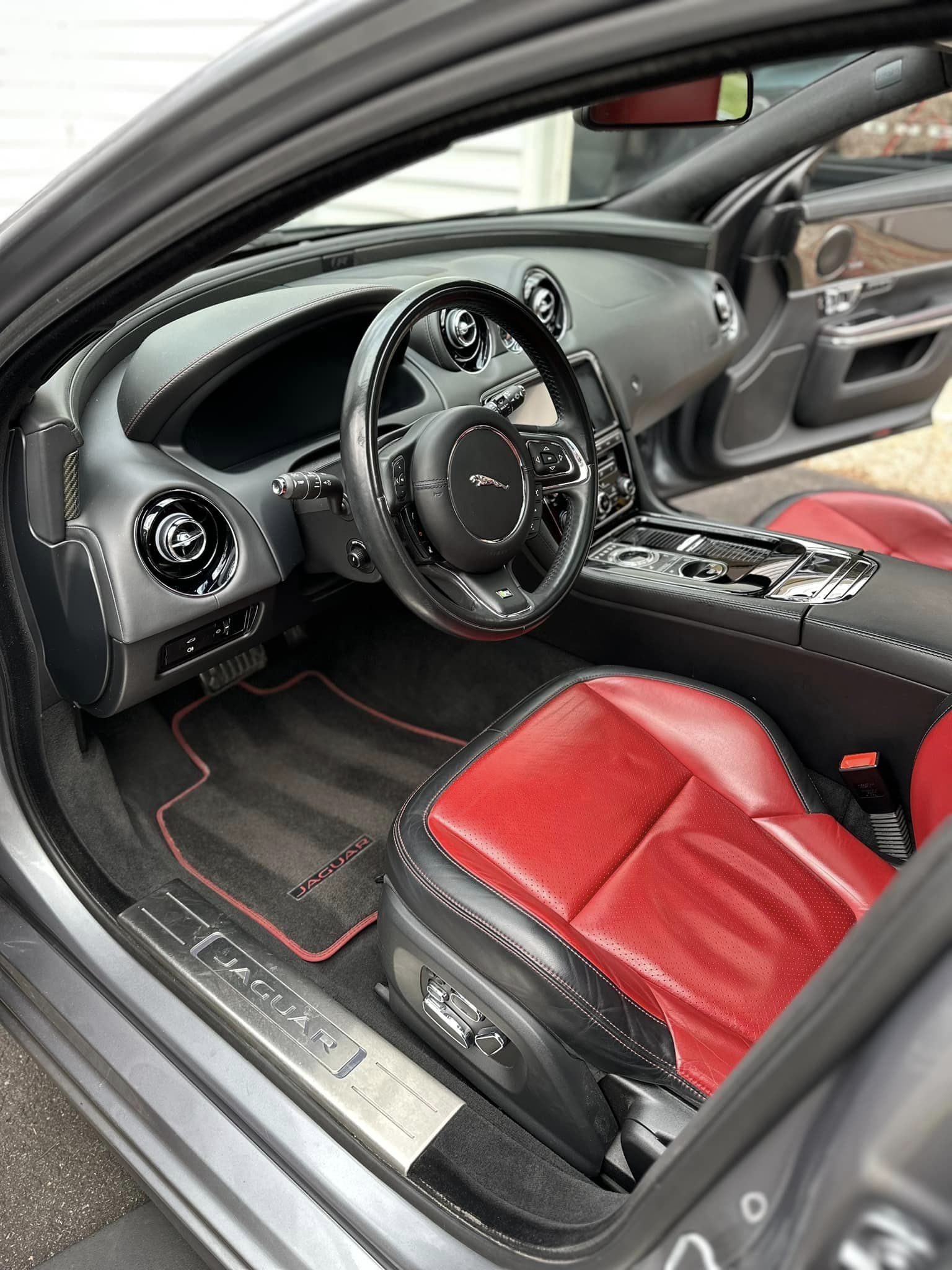 A Jaguar interior with red and black leather seats immaculately detailed