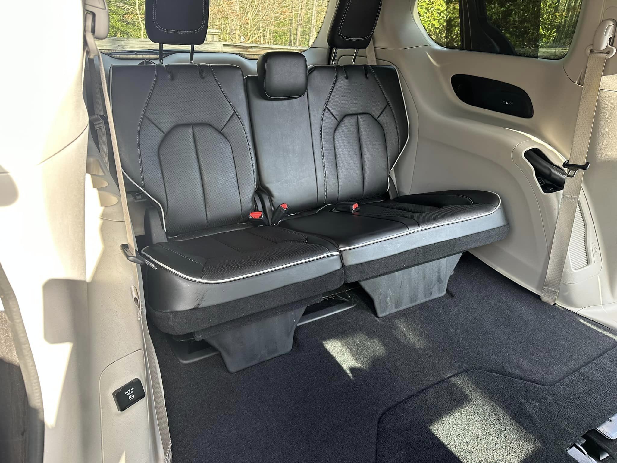 Rear seat of a tan Chevy interior, freshly detailed