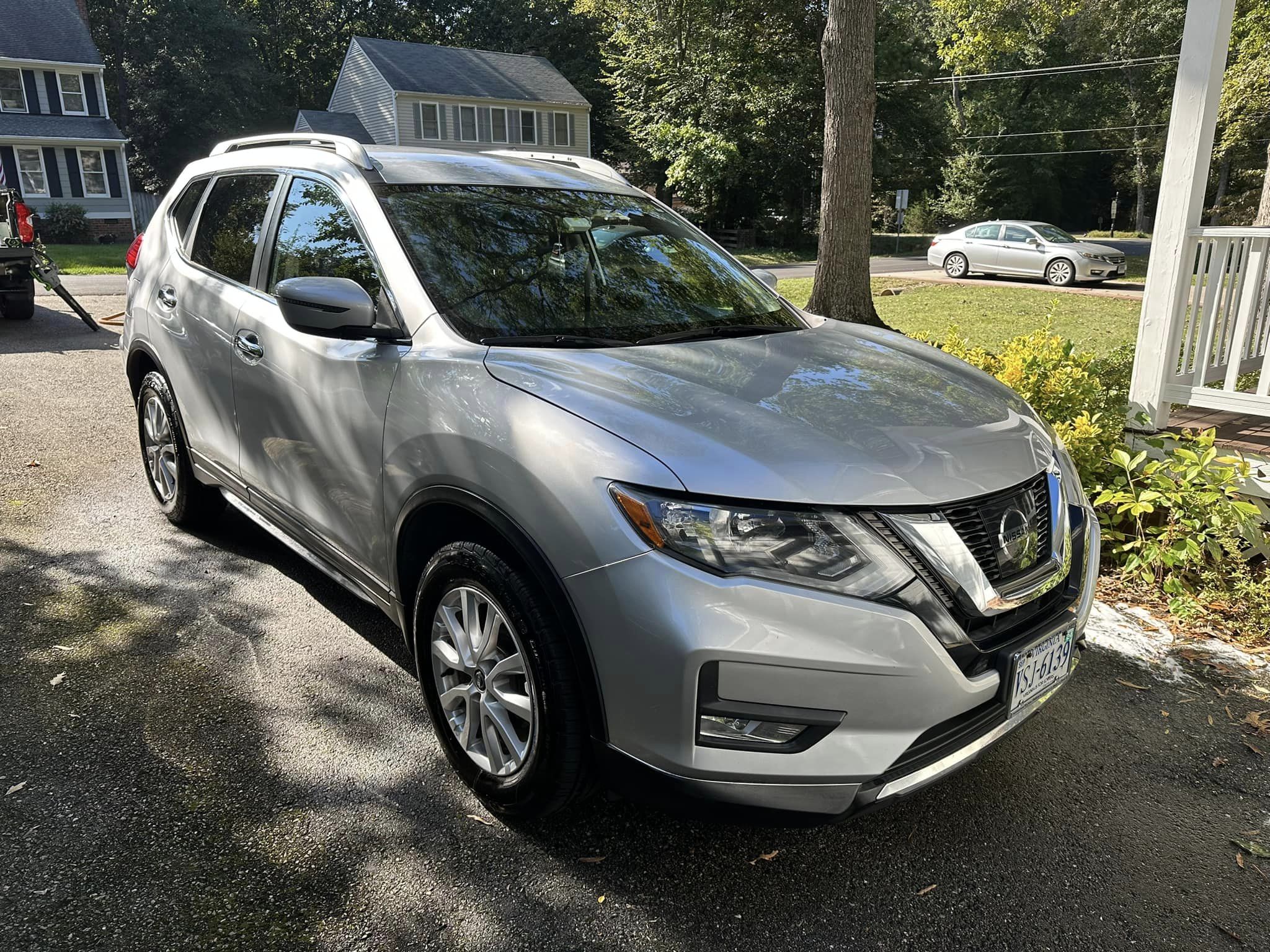 freshly washed silver nissan in a driveway