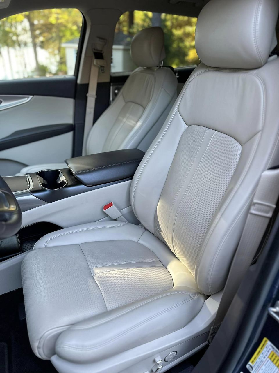 an immaculate interior with white leather seats after Parker's through interior detailing