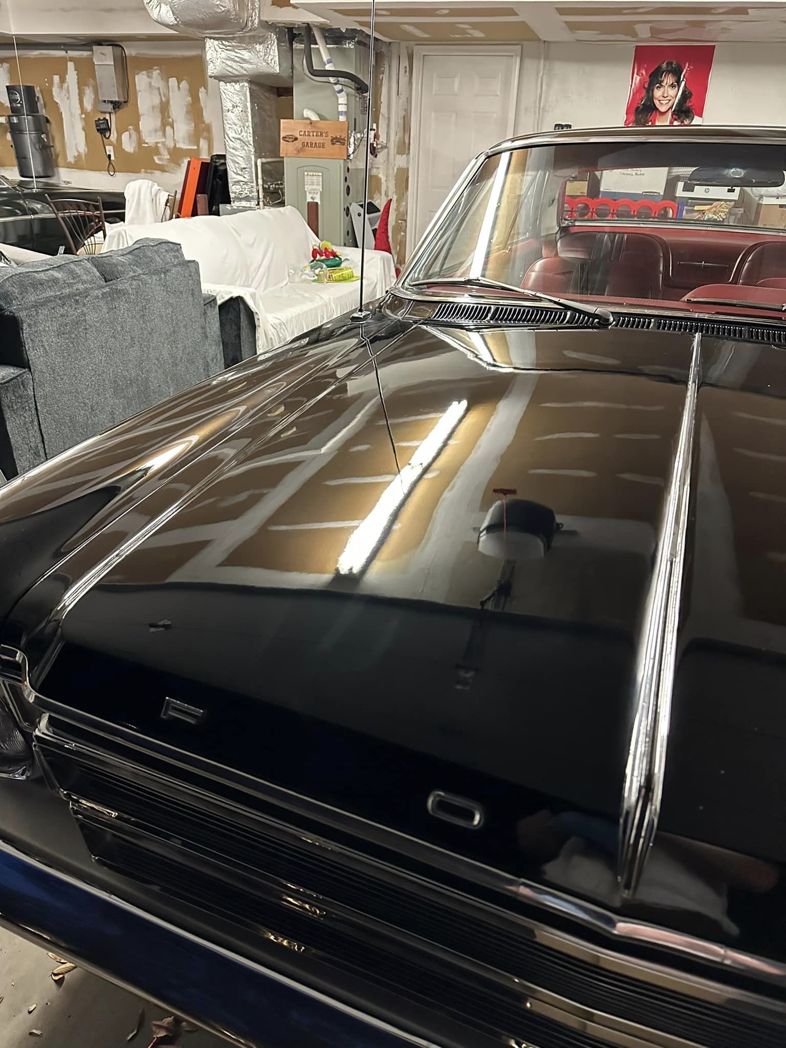 A black 66 Ford Galaxie hood closeup after paint correction