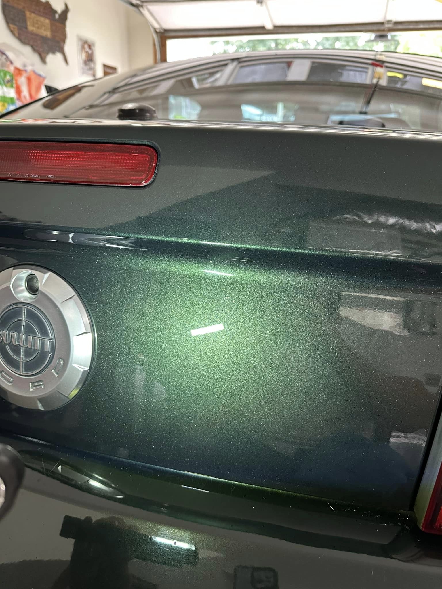 Closeup of the shining paint on a green Mustang