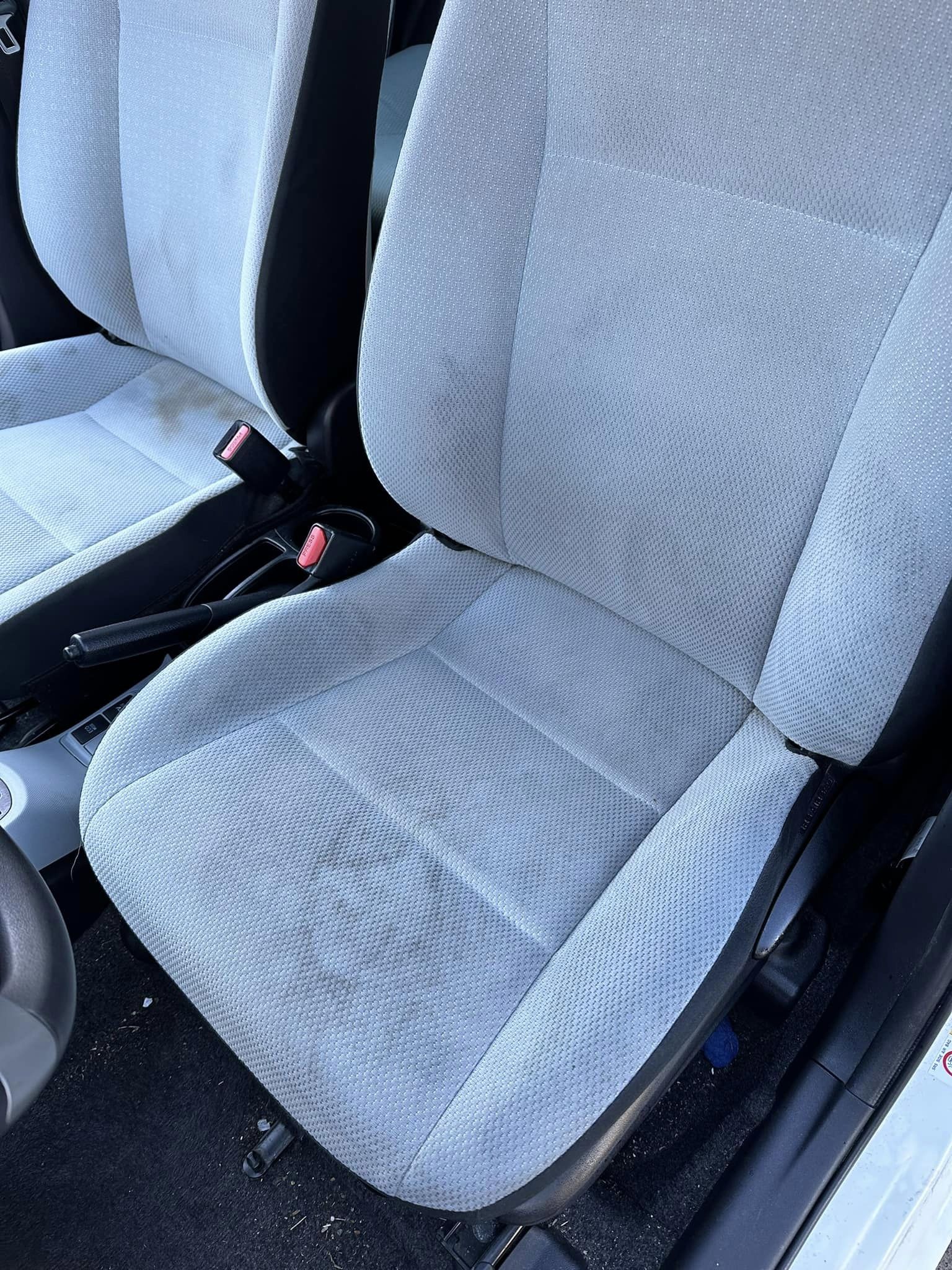 Dirty, stained white car seat before interior detailing