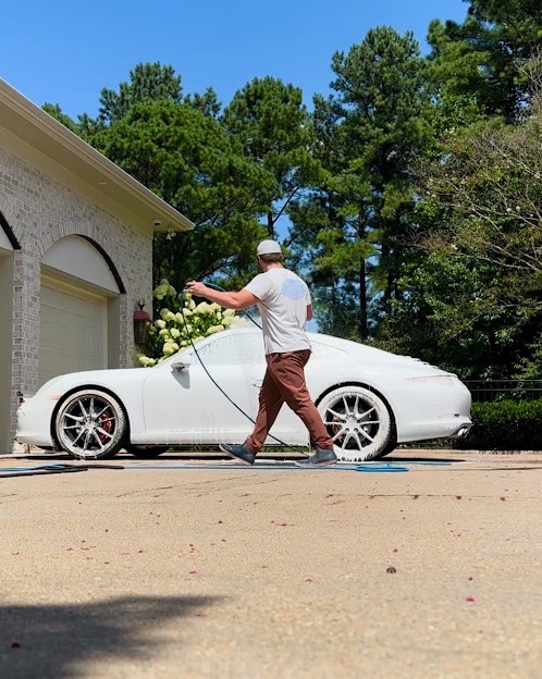 Parker washing white luxury car in driveway - mobile auto detailing service Chesterfield VA