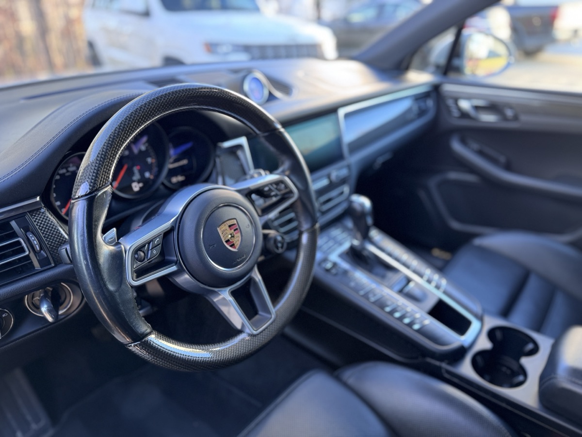 Porsche Macan GTS interior with steering wheel and dashboard after professional interior detailing