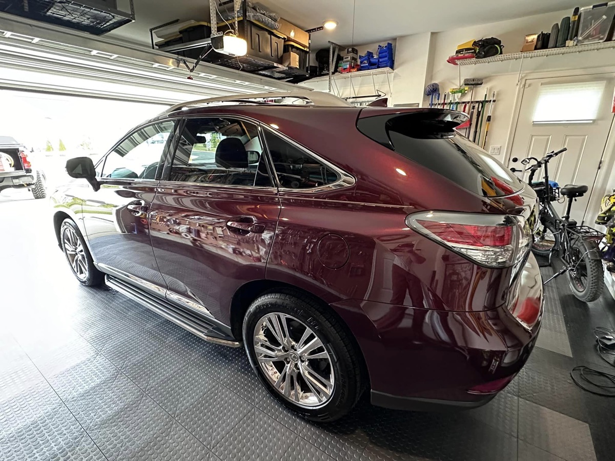 Dark cherry Lexus being machine polished during paint correction by Parker's Diamond Detailing